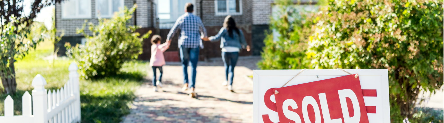 Personal insurance represented by family posing walking into new home