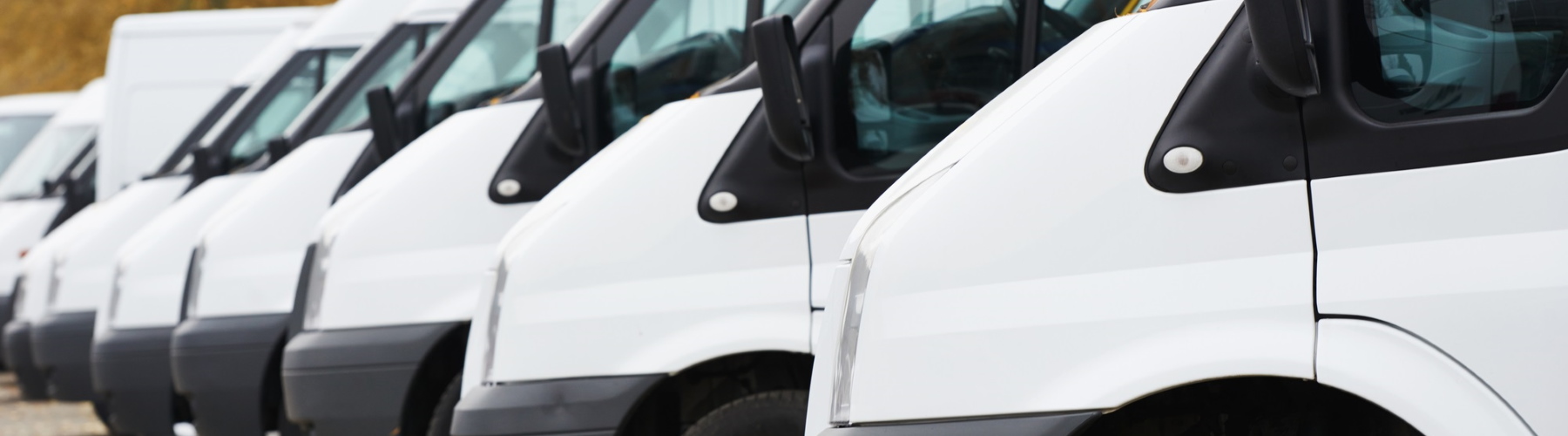 Row of commercial vans representing business insurance